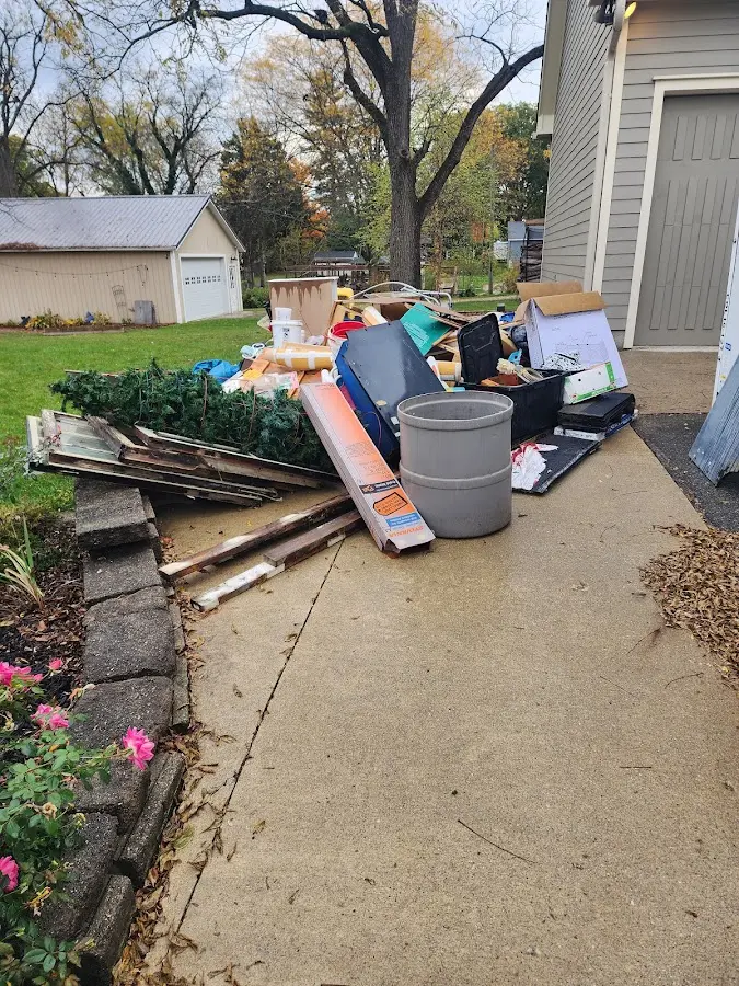 Dumpster being loaded with debris for Estate Cleanout Dumpster Rental in Sweetwater